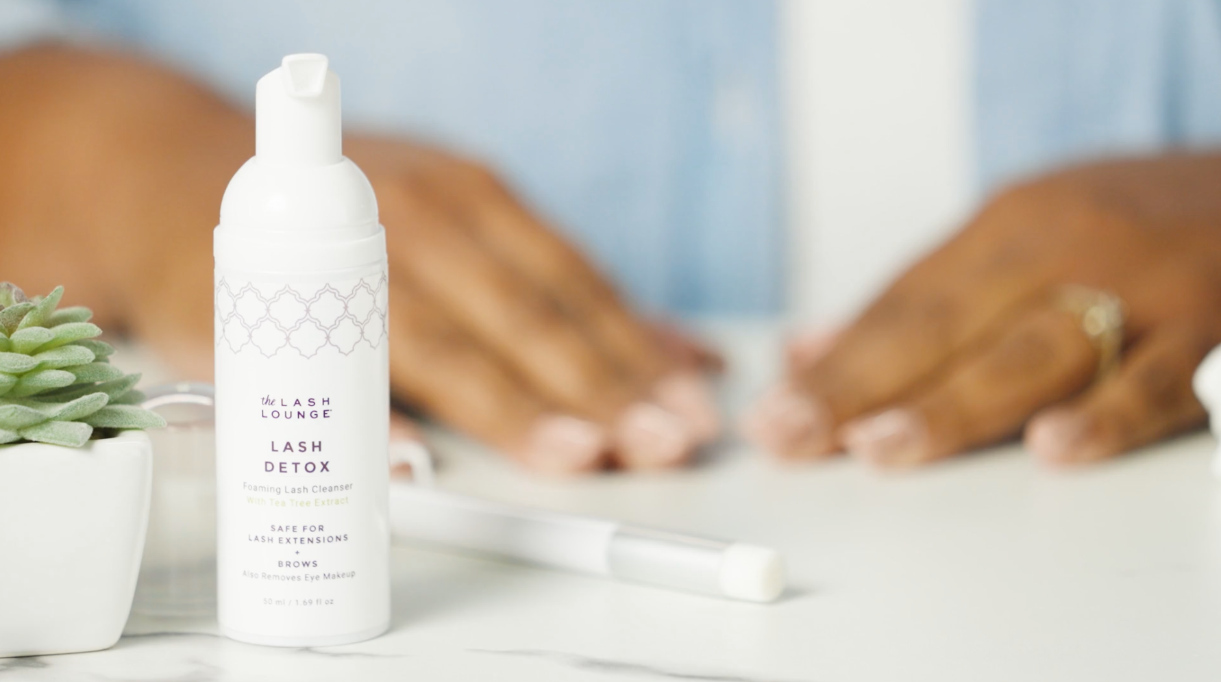 bottle of Lash Detox Cleanser for cleaning lash extensions sitting on counter